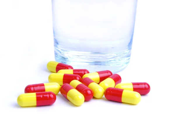 Pills and glass of water — Stock Photo, Image