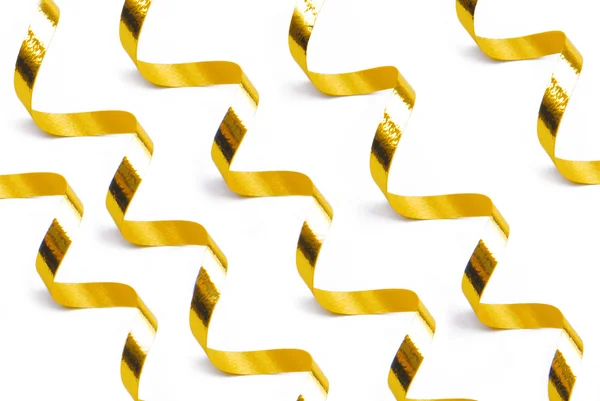 Golden confetti serpentine ribbon — Stock Photo, Image