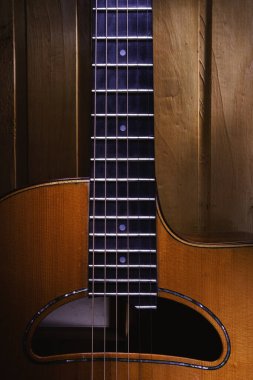 Beautifully gipsy jazz acoustic guitar details, hanged on wooden wall. clipart