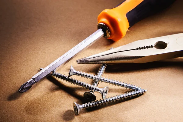 Abstract Composition One Screwdriver Pincers Few Screws — Stock Photo, Image