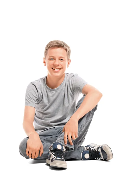 Happy teenage boy sitting on the floor — Stock Photo, Image