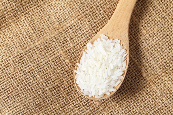 Rice with wooden spoon — Stok fotoğraf