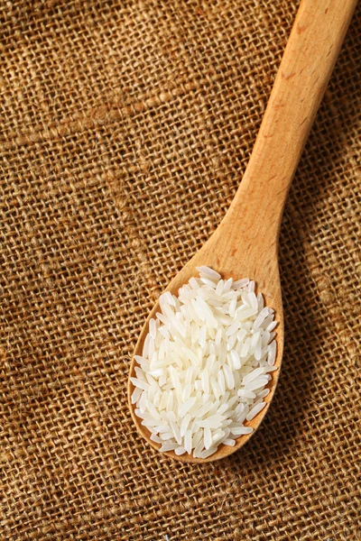 Rice with wooden spoon — Stok fotoğraf