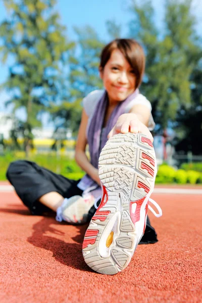 Woman doing stretching exercise in park — Stock Photo, Image