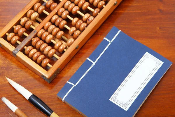 Chinese book , abacus and writing brush — Stock Photo, Image