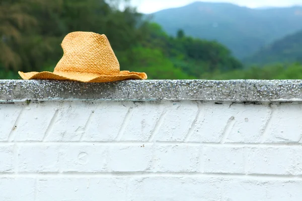 Плетеная шляпа на стене — стоковое фото