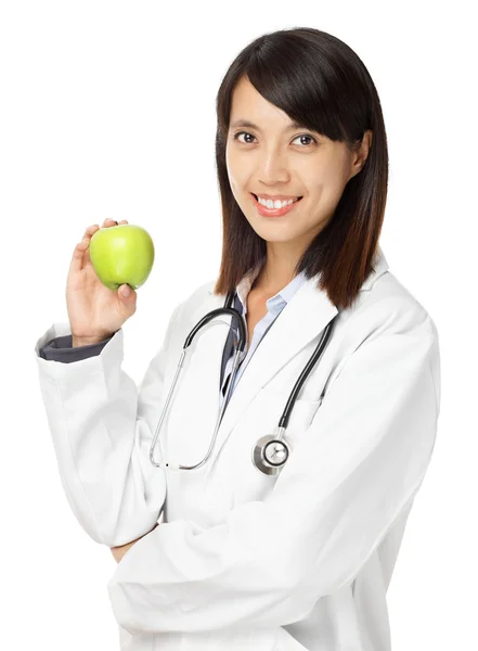 Asian female doctor holding green apple — Stock Photo, Image