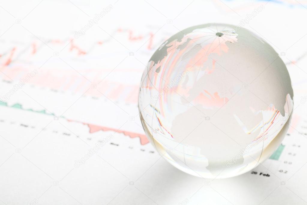 Glass earth ball on the financial chart
