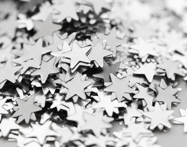 Scattered glittering stars confetti close up — Stock Photo, Image