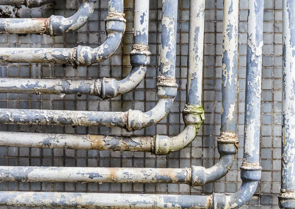 Series of parallel old pipes on wall — Zdjęcie stockowe