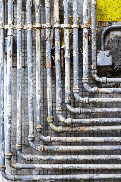 Series of parallel old pipes on wall — Stock Photo, Image