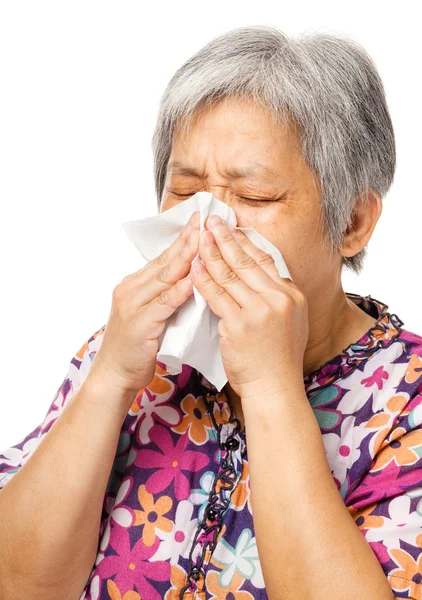 Sneezing mature asian woman — Stock Photo, Image