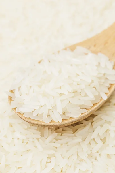 Uncooked white rice on spoon — Stock Photo, Image