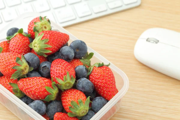 Berry mix lunch box in working desk — Stock Photo, Image