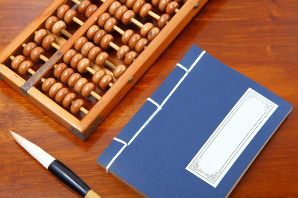 Chinese book , abacus and writing brush — Stock Photo, Image