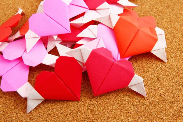 Group of origami colorful heart on corkboard — Stock Photo, Image
