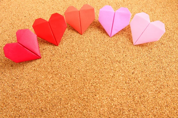 Origami cuore colorato su tavola da sughero — Foto Stock