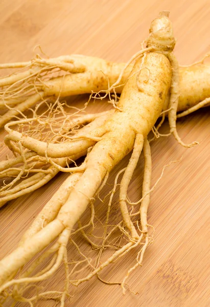 Fresh Ginseng on the wooden background — Stock Photo, Image