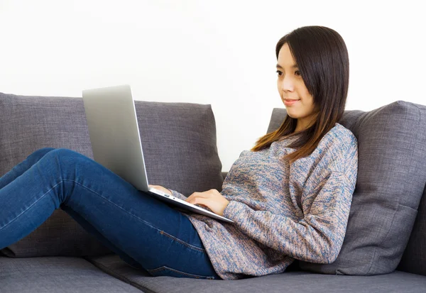 Vrouw op de Bank met behulp van laptop — Stockfoto