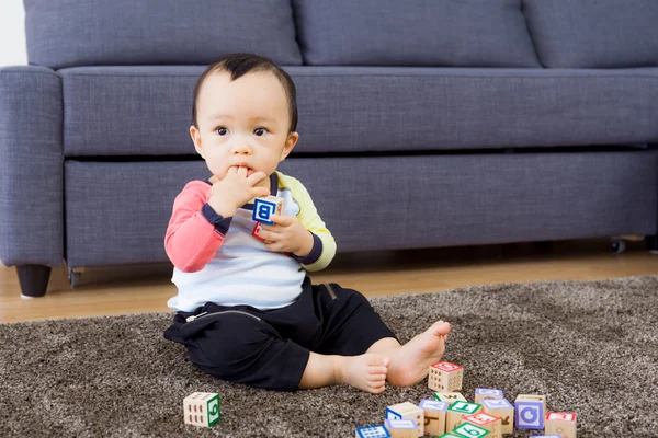 Asian baby boy with finger in mouth — Stock Photo, Image