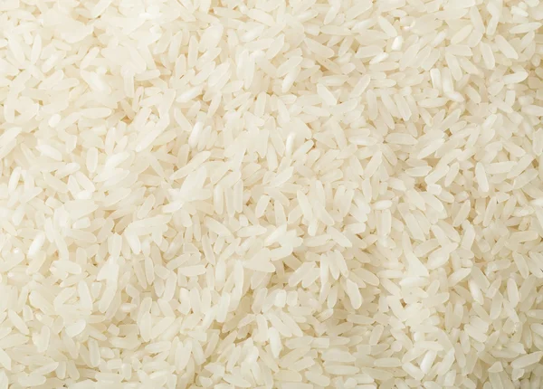Niegotowane tło białego ryżu — Zdjęcie stockowe