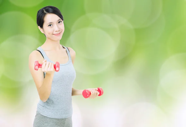 Woman lifting dumbbell — Stock Photo, Image