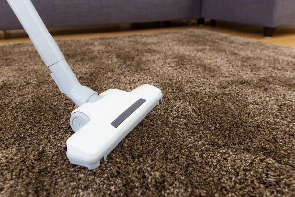 Brown carpet with vacuum cleaner in living room — Stock Photo, Image