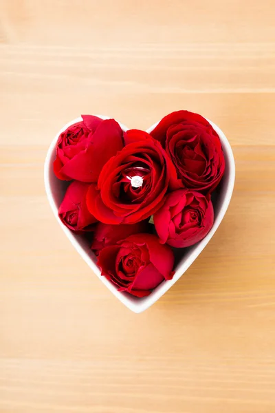 Red rose and diamond ring inside heart shape bowl — Stock Photo, Image