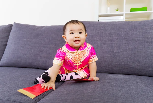 Chinese baby touching red pocket — Stock Photo, Image