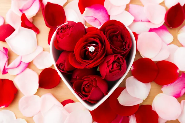 Rose and diamond ring inside the heart shape bowl — Stock Photo, Image