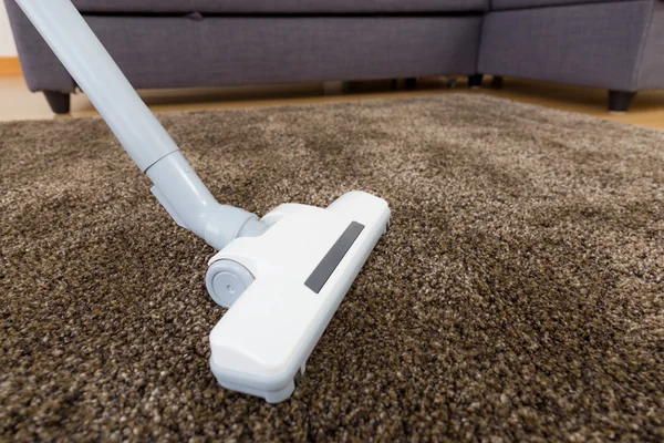 Cleaning carpet with vacuum — Stock Photo, Image