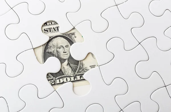 Conta de dólar e peça de quebra-cabeça — Fotografia de Stock