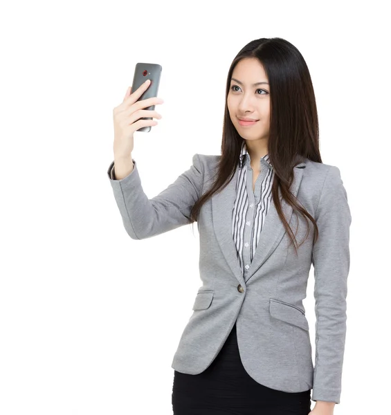 Asian businesswoman photographs herself — Stock Photo, Image