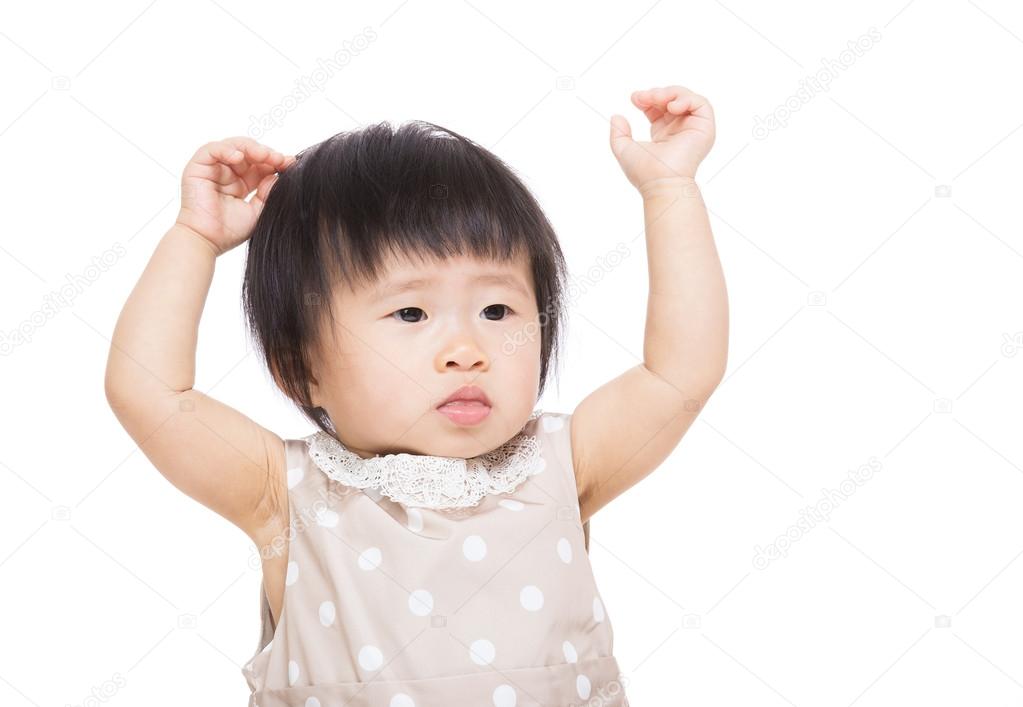 Asian baby girl raised two hands up
