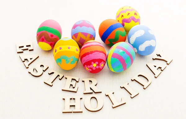 Easter eggs and wooden text — Stock Photo, Image