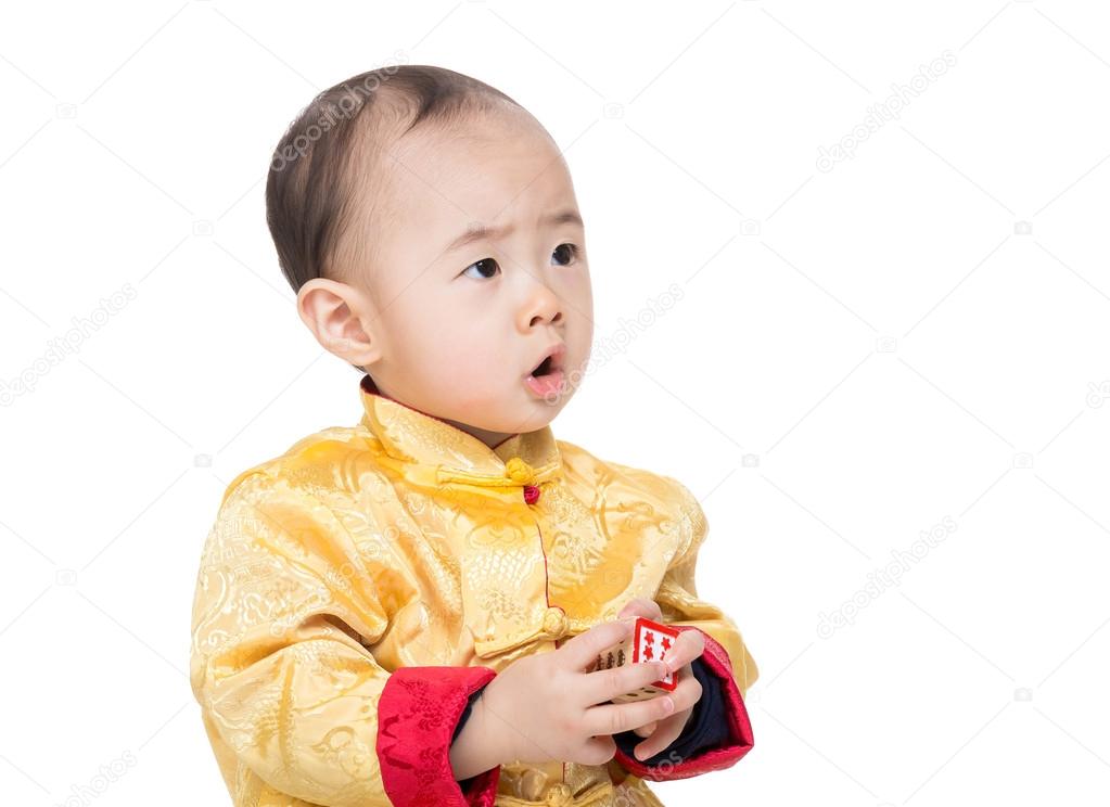 Chinese baby boy in traditional chinese costume play toy blocks