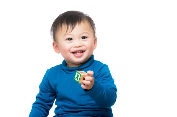 Asiático bebé niño sonriendo y sosteniendo madera juguete bloque — Foto de Stock