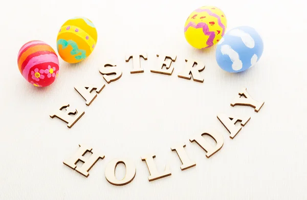 Kid Painted easter eggs with wooden text — Stock Photo, Image