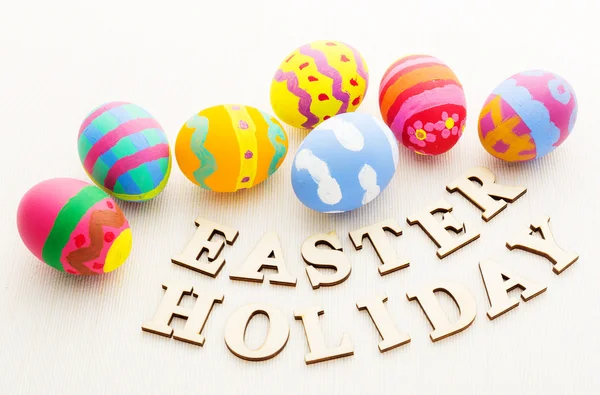 Easter eggs with wooden text — Stock Photo, Image