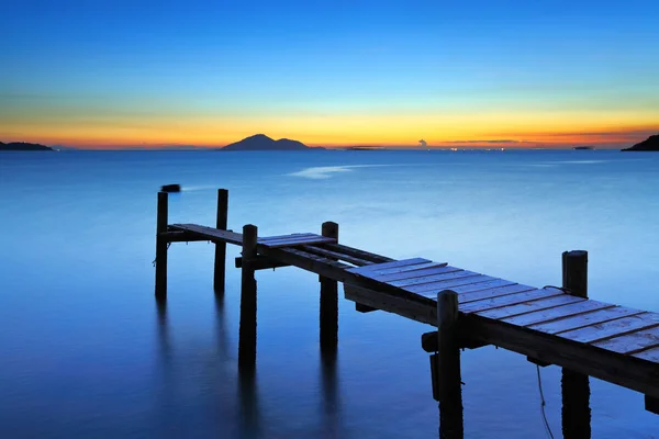 Ponte de madeira com paisagem marinha durante o sunet — Fotografia de Stock