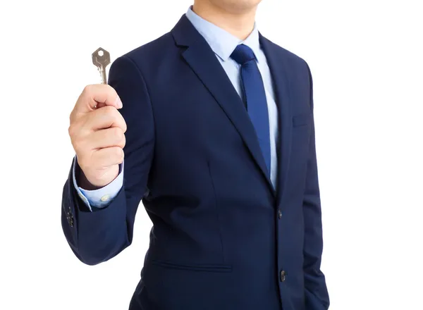Forretningsmann med nøkkel i hånden – stockfoto