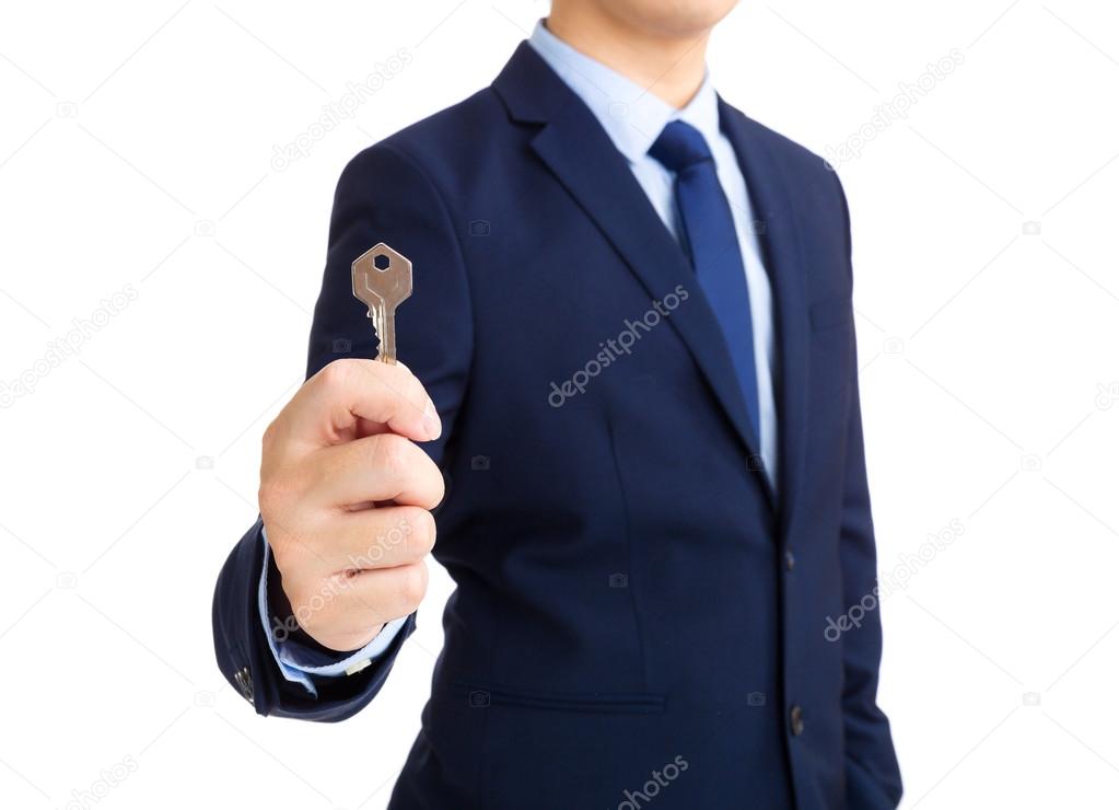 Businessman showing key to success