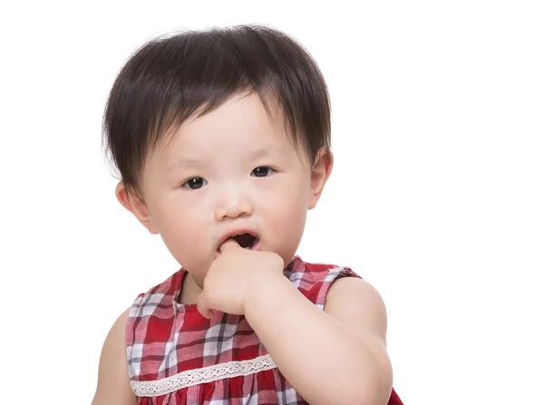 Asian little girl put finger into mouth — Stock Photo, Image