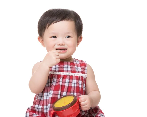 Asian little girl eating snack and holding food box — Stock Photo, Image