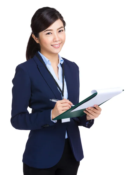Businesswoman record on clipboard — Stock Photo, Image