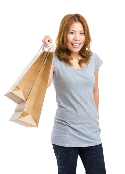 Mulher segurando saco de compras e sorrindo — Fotografia de Stock