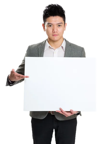 Businessman holding blank billboard — Stock Photo, Image