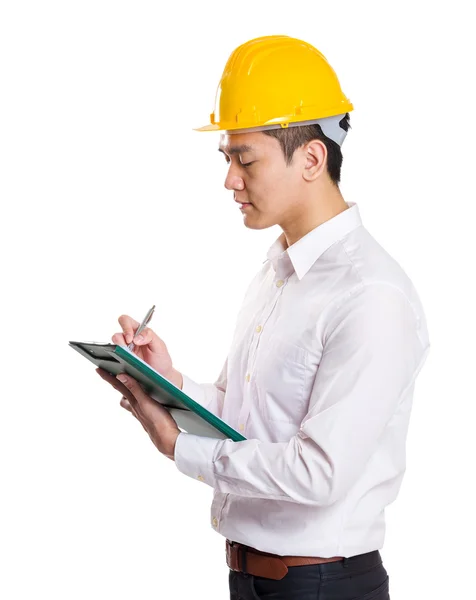 Young foreman taking note on clipboard — Stock Photo, Image