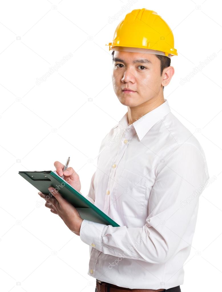 Young businessman architect writing on clipboard