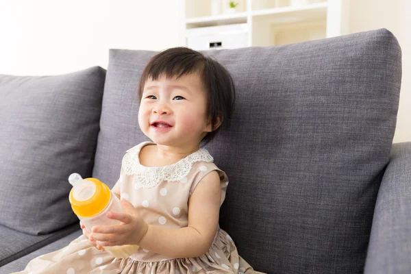 Азиатская девочка с бутылкой молока в руках — стоковое фото